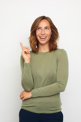 Wall Mural - portrait of young woman pointing at blank copyspace