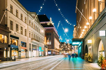 Helsinki, Finland. Night View Of Aleksanterinkatu Street With Railroad In Kluuvi District In Evening Christmas Xmas New Year Festive Illumination