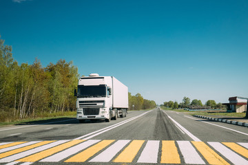 Wall Mural - Truck On Country Road. Tractor Unit, Prime Mover, Traction Unit In Motion On Countryside Road In Europe. Business Transportation And Trucking Industry Concept