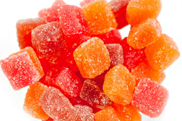 Red, yellow and orange jelly candies shot close up on a white background