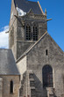 © jefwod - Historic church of Sainte mere l'eglise, with a paratrooper  hanging on the bell tower in Normady, France.