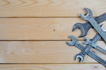 Old used wrenches on a wooden background. Vintage spanners