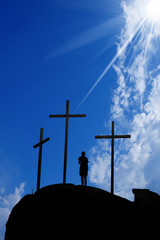 Wall Mural - Three crosses on the hill and a boy praying