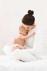 Wall Mural - Young mother holding her newborn child in hands