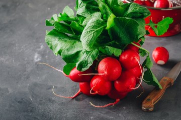 Wall Mural - Large bunch of raw fresh garden radish  in red colander