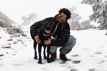 Man With Dog In Snow