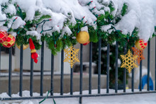 Railing Wrapped With Snowy Garland And Red Lights