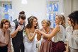 © Halfpoint - A young bride with other guests dancing and singing on a wedding reception.