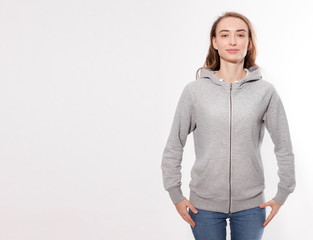 Wall Mural - Shirt design and fashion concept - young woman in gray sweatshirt, gray hoodies, blank isolated on white background