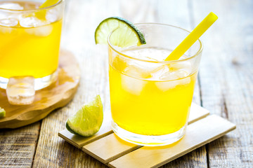 Sweet cocktails with lime and ice cubes on wooden tabel