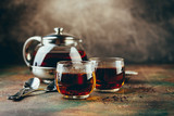 Transparent glass teapot black tea and glass cups