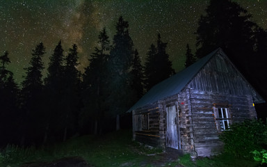 Wall Mural - Charming lunar and starry nights with the Milky way in the Ukrainian Carpathians with mountain houses.