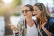 © goodluz - Smiling friends on shopping spree in the city