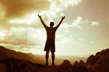 Wall Mural - silhouette of successful man on the top of mountain. Concept of sport motivation inspiration