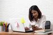 © suriya - Asian young Businesswoman working laptop computer on wood desk in Home office