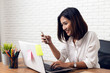 © suriya - Asian young Businesswoman working laptop computer on wood desk in Home office