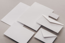 Flat Lay With White Papers And Envelopes On Grey Background