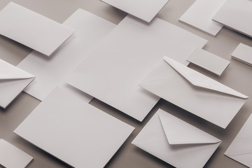 Wall Mural - close up of empty white papers and envelopes on grey background