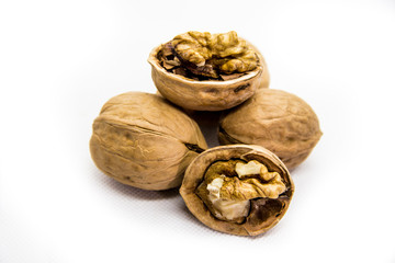 a few walnut in shell and peeled on white background