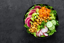 Salad Buddha Bowl With Fresh Cucumber, Celery, Watermelon Radish, Raw Carrot, Lettuce, Radish And Chickpea For Lunch. Healthy Vegetarian Food. Vegan Vegetable Dish. Top View