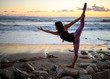 © Matt Dayka - Woman doing a yoga pose on the beach
