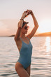 © pha88 - Girl with a gorgeous figure on the sea during sunset.Sexy girl on a wild beach.The girl in the water