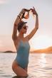 © pha88 - Girl with a gorgeous figure on the sea during sunset.Sexy girl on a wild beach.The girl in the water