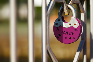 old style rare lock on a bridge with poland and hungary labels on it symbolized forever love and fri