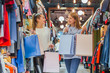 © Andrii - Happy women with shopping bags in the store