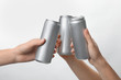 People holding aluminum cans on white background, closeup. Space for design