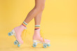 © New Africa - Young woman with retro roller skates on color background, closeup
