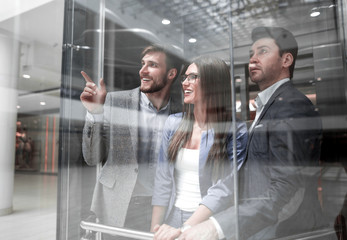 Wall Mural - group of business people standing in glass Elevato