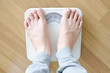 © Photo Sesaon - Legs of men standing on scales weight. Concept of health and weight loss.