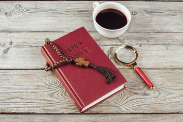 Sticker - Bible and a crucifix on an old wooden table. Religion concept.