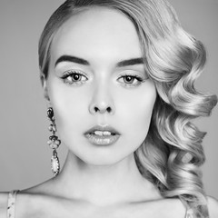 Fashion studio portrait of beautiful blonde woman with classic makeup