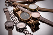© LIGHTFIELD STUDIOS - selective focus of luxury wristwatches on grey background