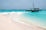 Fototapeta Na sufit - anchored boat by the sandy beach