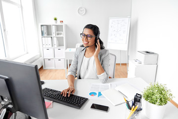 Sticker - communication, business, people and technology concept - indian businesswoman or helpline operator with headset and computer talking and typing at office