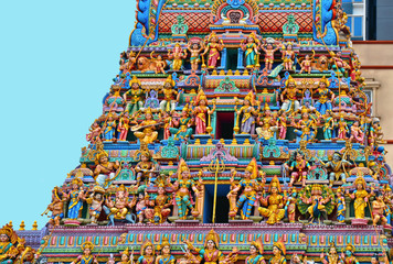 Colorful Sculpture, architecture and symbols of Hindu temple at Singapore , Sri Veeramakaliamman Temple with modern architecture in background.