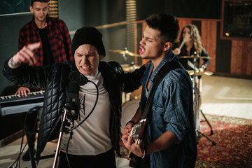 Wall Mural - Music band having rehearsal in a studio