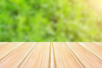 Wall Mural - Empty wooden table with blurred green background. concept party, products, spring