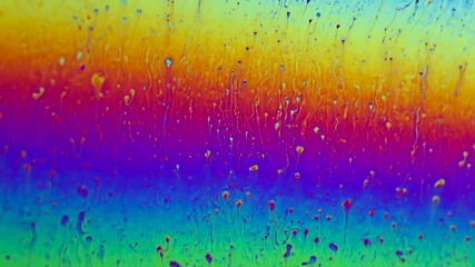Wall Mural - Surface tension with swirling shapes and colors on a soap film