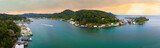 Fototapeta  - 180 degree aerial panorama of Roatan at sunrise.