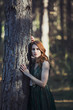 © Esteban - beautiful young redhead woman in green dress in the forest