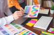 © snowing12 - Graphic design partners working together renovation and technology concept - on a desktop computer and selection using some color swatches