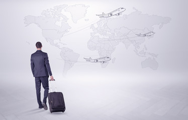 Businessman in dark suit planning his trip in a front of a map
