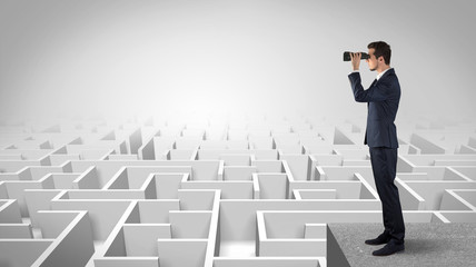 Wall Mural - businessman standing on maze and looking forward to the future concept