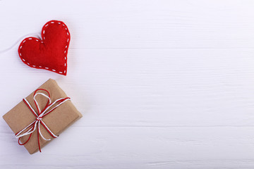 Red heart made of felt and handmade, on a white wooden table, Concept, banner, save space.