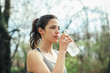 © GAGO IMAGES - Young woman drinking water from bottle
