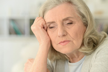 Canvas Print - portrait of tired senior woman at home